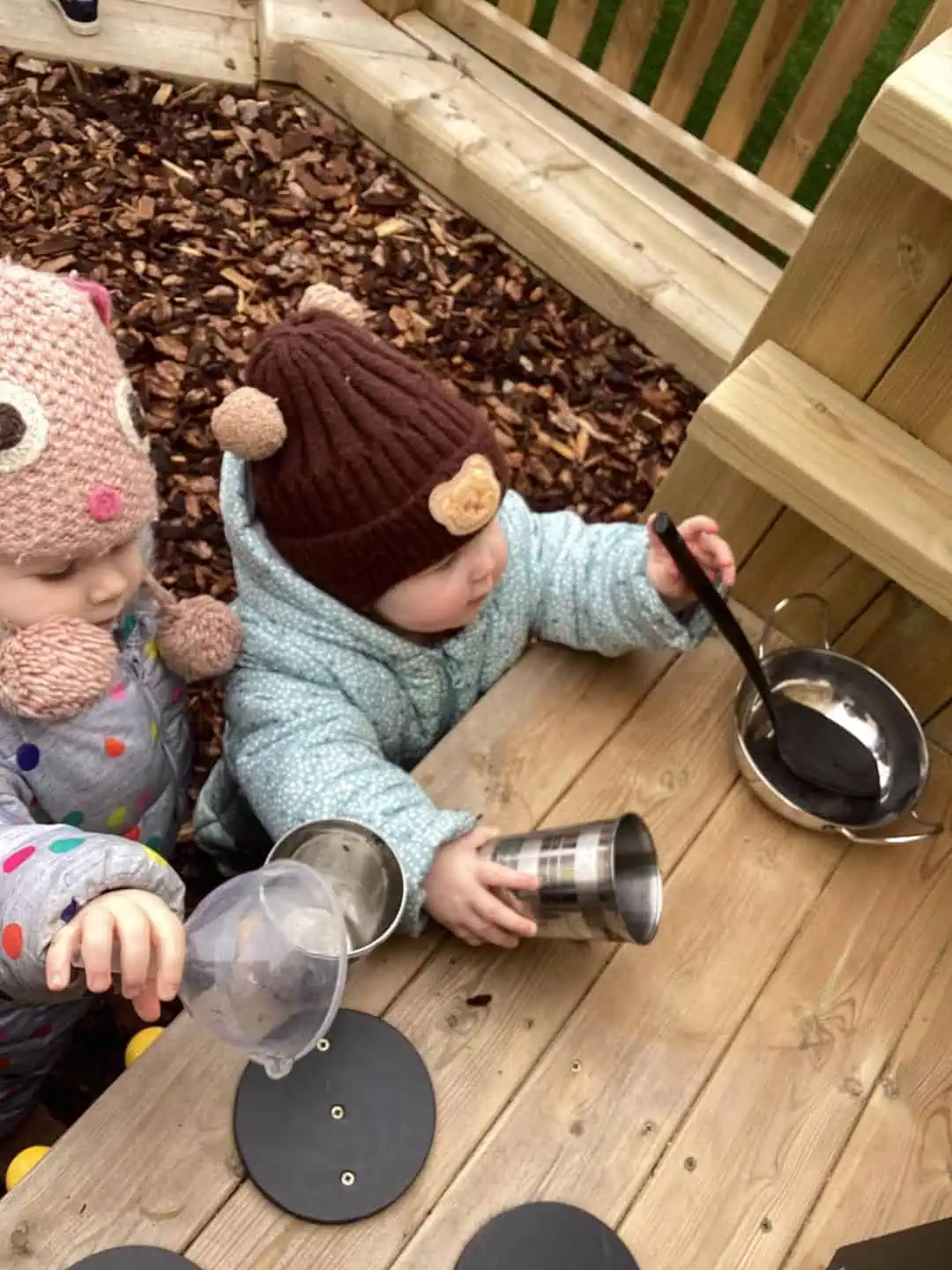 Children exploring Seer Green mud kitchen in our nursery and preschool close to Beaconsfield
